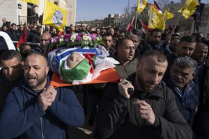 File - Mourners carry the body of 78-year-old Omar Asaad, a Palestinian who has U.S. citizenship, during his funeral in the West Bank village of Jiljiliya, north of Ramallah, Jan. 13, 2022. An autopsy, undertaken by three Palestinian doctors, confirmed that Asaad, who was pronounced dead shortly after being detained by Israeli troops in the occupied West Bank, died of a heart attack caused by “external violence.”