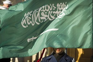 FILE - In this March 22, 2018 file photo, an Honor Guard member is covered by the flag of Saudi Arabia as Defense Secretary Jim Mattis welcomes Saudi Crown Prince Mohammed bin Salman to the Pentagon with an Honor Cordon, in Washington Saudi Arabia’s Interior Ministry said Tuesday, April 23, 2019, that 37 Saudi citizens have been beheaded in a mass execution that took place across various regions of the country.