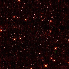 File - Asteroid 2010 TK7 is circled in green, in this single frame taken by NASA's Wide-field Infrared Survey Explorer, or WISE. The majority of the other dots are stars or galaxies far beyond our solar system.