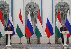 Hungary's Prime Minister Viktor Orban, left, and Russian President Vladimir Putin attend a joint news conference