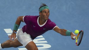 Rafael Nadal of Spain plays a forehand return to Daniil Medvedev of Russia during the men's singles final at the Australian Open tennis championships in Melbourne, Australia, Sunday, Jan. 30, 2022.