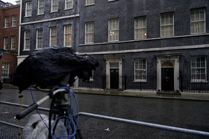 A television camera covered from the rain points towards the front door of 10 Downing Street, in London, Friday, Feb. 4, 2022.