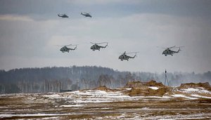 In this photo taken from video and released by the Russian Defense Ministry Press Service on Friday, Feb. 4, 2022, military helicopters take part in the Belarusian and Russian joint military drills at Brestsky firing range, Belarus. Russian and Belarus troops held joint combat training at firing ranges in Belarus.