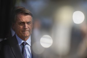 Brazil's President Jair Bolsonaro arrives for a seventh-day Mass in memory of his late mother Olinda Bonturi Bolsonaro at the Queen of Peace Cathedral in Brasilia, Brazil, Thursday, Jan. 27, 2022.