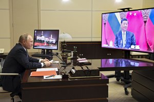 File - Russian President Vladimir Putin talks with Chinese President Xi Jinping via videoconference at the Novo-Ogaryovo residence outside Moscow, Russia, Dec. 15, 2021. Chinese President Xi Jinping supported Russian President Vladimir Putin in his push to get Western security guarantees precluding NATO's eastward expansion, the Kremlin said Wednesday after the two leaders held a virtual summit. Putin and Xi spoke as Moscow faces heightened tensions with the West over a Russian troop buildup near Ukraine's border.