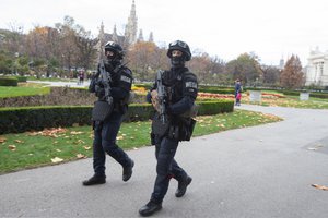 Armed police officers from the Wega special unit patrol the Volksgarten in the city center in Vienna during the coronavirus pandemic on November 17, 2020, Austria