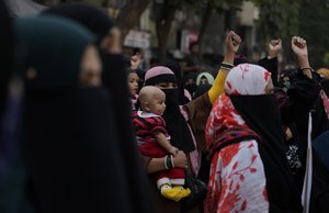 Indian Muslim women shout slogans against banning Muslim girls wearing hijab from attending classes at some schools in the southern Indian state of Karnataka during a protest in Mumbai, India, Sunday, Feb. 13, 2022.