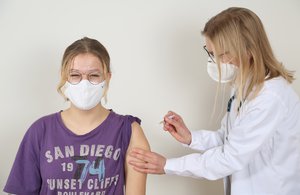 Medical student Costanza Richter (R) gives patient Nelly van Buuren a flu vaccination on December 19, 2020, in Berlin, Germany