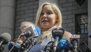 File - Virginia Roberts Giuffre holds a news conference outside a Manhattan court following the jailhouse death of Jeffrey Epstein, Aug. 27, 2019, in New York. A tentative settlement has been reached in a lawsuit accusing Prince Andrew of sexually abusing a 17-year-old American, according to a court filing Tuesday, Feb. 15, 2022.