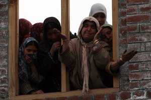 Kashmiri women mourn during the funeral of slain Indian army soldier Shabir Ahmed Malik at Dab Wakoora, northeast of Srinagar on March 24, 2009. An army statement said that eight soldiers and 16 rebels have died in the fighting in Kupwara district close to the Line of Control that divides the Indian and Pakistani-controlled parts of the Himalayan region so far. Well attended funerals for militants, fighting Indian rule in Kashmir, are common but it is for the first time that an Indian soldier's death was mourned in a region where anti-India sentiments run deep.