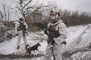 Ukrainian servicemen provide area security during a visit by Gen. Oleksandr Pavliuk, commander of the Joint Forces Operation, to frontline positions outside Avdiivka, Donetsk region, eastern Ukraine, Wednesday, Feb. 9, 2022