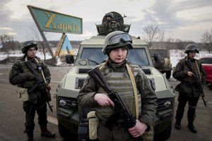 Ukrainian National guard soldiers guard a mobile checkpoint together with the Ukrainian Security Service agents and police officers during a joint operation in Kharkiv, Ukraine, Thursday, Feb. 17, 2022