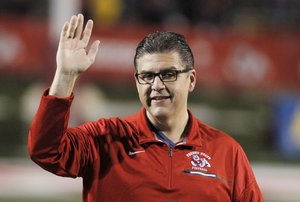 FILE - Joseph I. Castro, at the time president of Fresno State, waves to the crowd before the team's NCAA college football game Nov. 4, 2017, against BYU in Fresno, Calif.