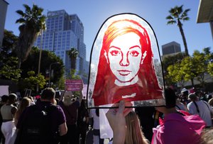 A Rubylith printing screen featuring a portrait of Britney Spears is held by Spears supporter Taylor Coppage outside a hearing concerning the pop singer's conservatorship at the Stanley Mosk Courthouse, Friday, Nov. 12, 2021, in Los Angeles.