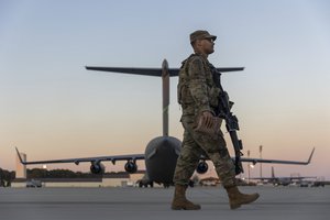 Members of the 82nd Airborne Division of the U.S. Army walk on the tarmac at Pope Field ahead of deployment to Poland from Fort Bragg, N.C. on Monday, Feb. 14, 2022.