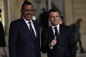 France's President Emmanuel Macron, right welcomes Niger's President Mohamed Bazoum for a meeting at the Elysee Palace, in Paris, France, Wednesday, Feb. 16, 2022.