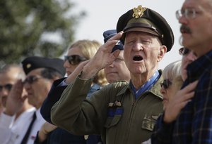 Retired Col. Gail Halvorsen sings "The Star-Spangled Banner" as the colors are presented during a Veterans Day ceremony at Fort Sam Houston National Cemetery, Monday, Nov. 11, 2013, in San Antonio.