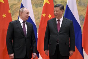 Chinese President Xi Jinping, right, and Russian President Vladimir Putin talk to each other during their meeting in Beijing, China, Friday, Feb. 4, 2022. Russian President Vladimir Putin is in Beijing for the Winter Olympics and talks with his Chinese counterpart Xi Jinping, amid soaring tensions with Ukraine.