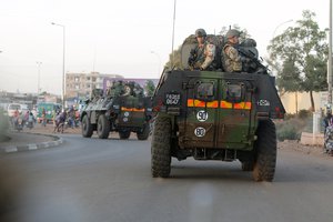 French troops in two armored personnel carriers drive through Mali's capital Bamako on the road to Mopti, Tuesday, Jan. 15, 2013