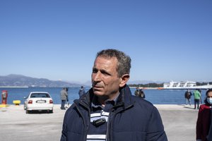 Kostas Mathios speaks to journalist at the port in Corfu, Greece, as his brother in law is missing following a fire at the Italian-flagged ferry Euroferry Olympia, on Saturday, Feb. 19, 2022