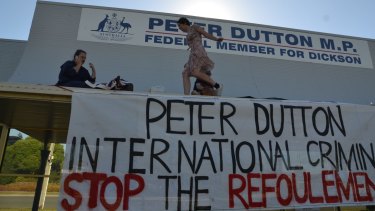 Protesters who climbed onto the awning of Immigration Minister Peter Dutton's office have been fined.