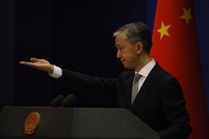 Foreign Ministry spokesperson Wang Wenbin gestures for questions during a daily briefing in Beijing Thursday, July 23, 2020