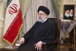 In this photo released by the official website of the office of the Iranian Presidency, President Ebrahim Raisi speaks in a live televised interview with state-run TV, in Tehran, Iran, Tuesday, Jan. 25, 2022