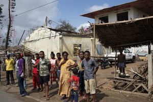 People outside ruined homes in Mananjary, Madagascar, Feb. 10, 2022