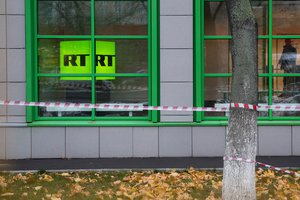 FILE - In this Oct. 27, 2017, file photo, Russian state-owned television station RT logo is seen at the window of the company's office in Moscow, Russia.