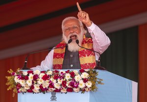 Indian Prime Minister Narendra Modi gestures as he speaks during a public rally in Dhekiajuli, Assam, India, Sunday, Feb. 7, 2021.