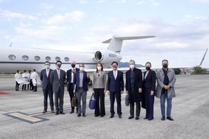 In this photo released by Taiwan's Ministry of Foreign Affairs, Taiwan's Foreign Minister Joseph Wu, fourth from right, stands with an American delegation including former Chairman of the Joint Chiefs Adm. Mike Mullen, third from right, as they arrive at Taipei Songshan Airport in Taipei, Taiwan, Tuesday, March 1, 2022.