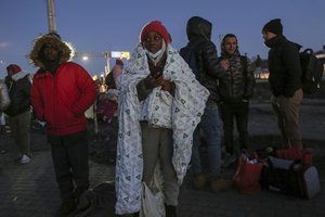 A student covers herself in blanket at the Medyka border crossing after fleeing from the Ukraine, in Poland, Monday, Feb. 28, 2022.