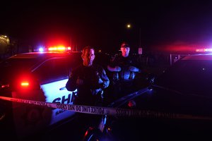 Sacramento County Sheriff's deputies stand by police tape that blocks the street leading to a church where a shooting occurred with multiple victims, in Sacramento, Calif., Monday, Feb. 28, 2022.