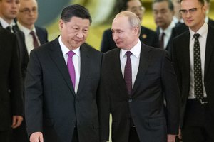 FILE - In this June 5, 2019, file photo, Russian President Vladimir Putin, center right, and Chinese President Xi Jinping, center left, enter a hall for the talks in the Kremlin in Moscow, Russia.