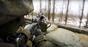 In this photo taken from video released by the Russian Defense Ministry Press Service on Thursday, March 3, 2022, a Russian soldier points a gun from a Russian military truck as it drives through an undisclosed location in Ukraine.