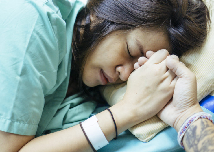 Photo of Asian woman receiving birthing support during pregnancy