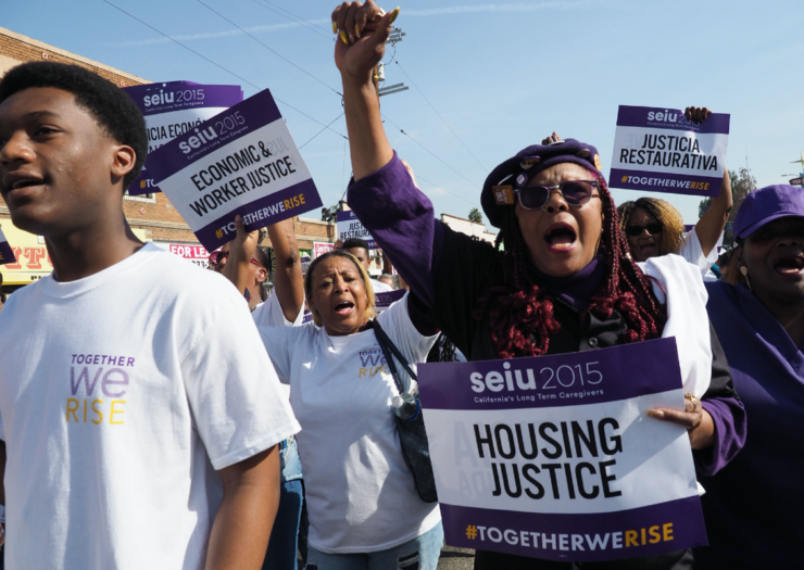 [Protesters marching for housing justice]