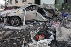 The lifeless body of a man killed in a Russian rocket attack lies amid debris, in Kharkiv, Ukraine's second-largest city, Sunday, March 6, 2022