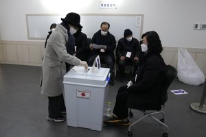 A voter casts a ballot for the presidential election at a local polling station in Seoul, South Korea, Wednesday, March 9, 2022