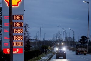 Farmer Dimitris Kakalis, 25, driving his tractor, approaches a gas station, in Tyrnavos town, central Greece, Sunday, Feb. 13, 2022.