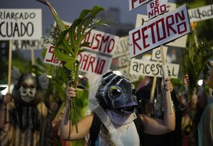 Women march shouting slogans against Brazil's President Jair Bolsonaro and holding signs in support of the preservation of the Amazon, to mark International Women's Day in Sao Paulo, Brazil, Tuesday, March 8, 2022.