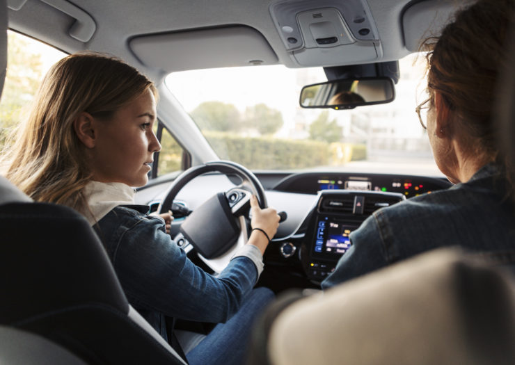 Photo of teen behind the wheel with parent in the passenger seat