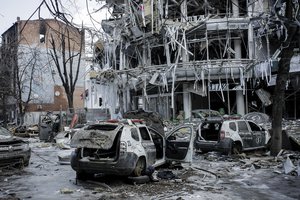 Damaged vehicles sit among debris and in Kharkiv city center in Ukraine, Wednesday, March 16, 2022