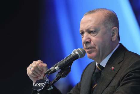 Turkey's President Recep Tayyip Erdogan gestures as he delivers a speechduring his ruling party's congress inside a packed sports hall in Ankara, Turkey, Wednesday, March 24, 2021.