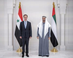 In this photo released by the Emirates News Agency, WAM, Abu Dhabi's powerful crown prince, Sheikh Mohammed bin Zayed Al Nahyan, right, and Syrian President Bashar Assad pose for a photo during their meeting in Abu Dhabi, United Arab Emirates, Friday March 18, 2022