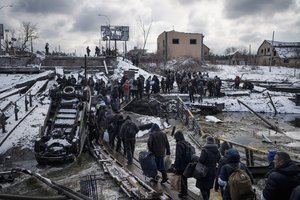 Ukrainians cross an improvised path under a destroyed bridge while fleeing Irpin, on the outskirts of Kyiv, Ukraine, March 8, 2022