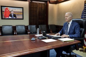 In this photo provided by the White House, US President Joe Biden is shown during a video call with his Chinese counterpart Xi Jinping, Friday, March 18, 2022, in Washington