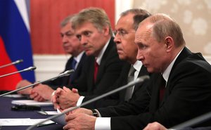 Russian President Vladimir Putin during a conversation with French President Emmanuel Macron during a roundtable with delegation