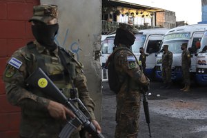 Soldiers stand guard at a bus terminal in San Salvador, El Salvador, Monday, March 14, 2022.