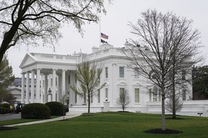 An American flag flies at half-staff in remembrance of former Secretary of State Madeleine Albright above the White House in Washington, Thursday, March 24, 2022.